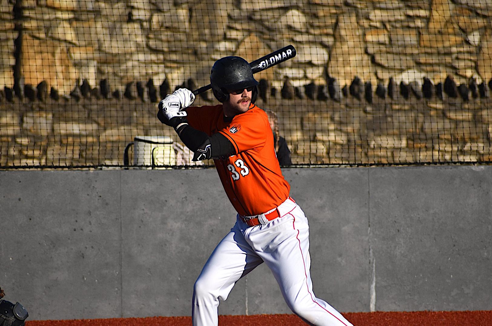Baker baseball's TJ Armstrong hitting at home against Doane