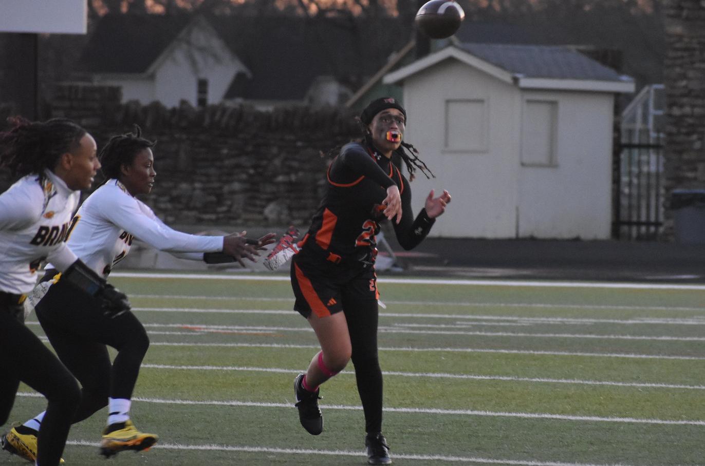 Baker women's flag football quarterback Sanija Waller throwing a pass at home against Ottawa