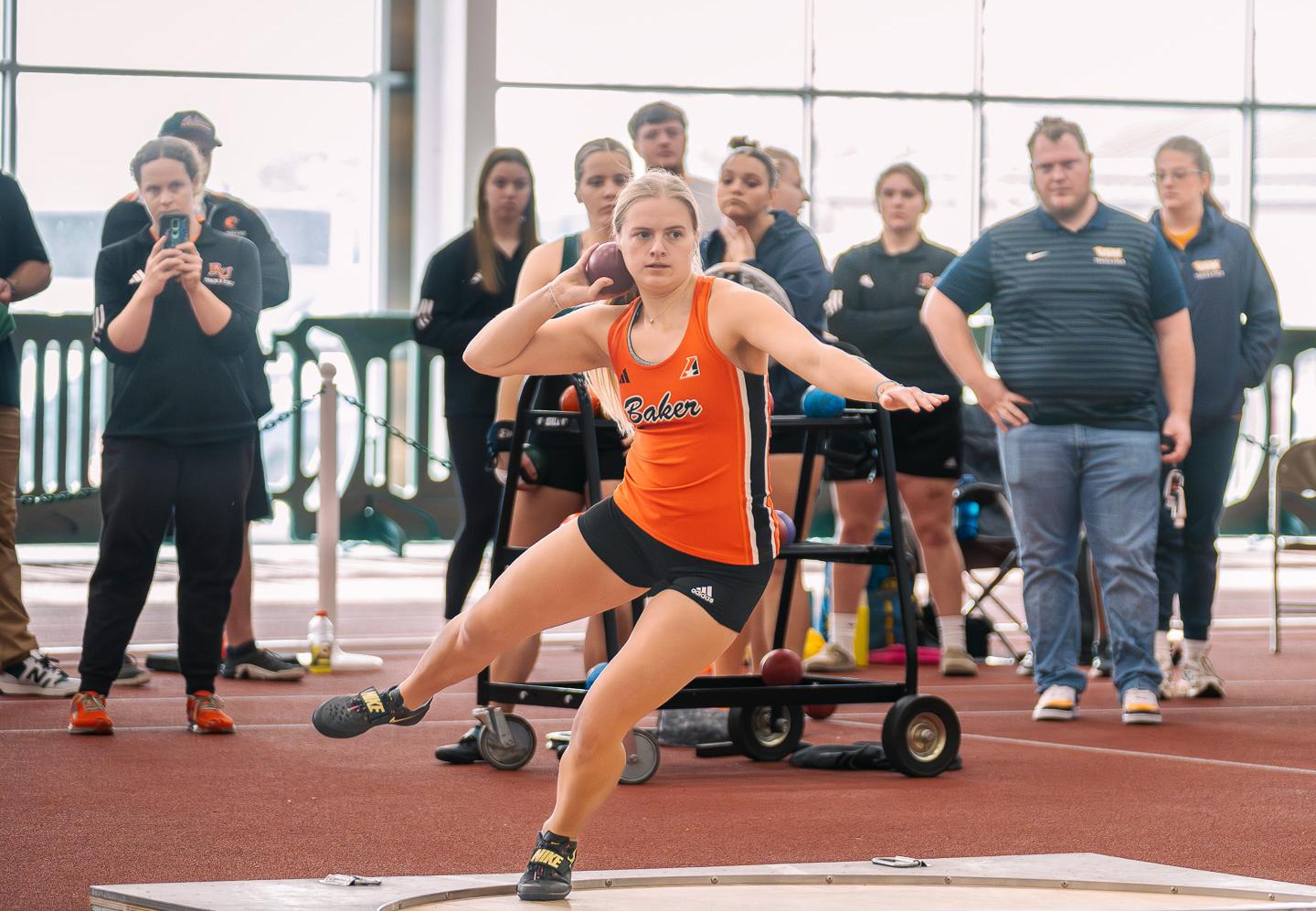 Baker women's track and field athlete Julie Coffey throwing the shot put at Northwest Missouri State